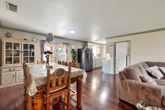 805 Loganwood Dr, Royse City, TX 75189 - dining room with crown molding, french doors, and dark wood-type flooring