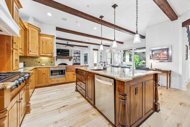933 Glenhurst Rd, Keller, TX 76248 - kitchen featuring appliances with stainless steel finishes, a sink, beamed ceiling, custom exhaust hood, and a fireplace