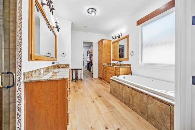933 Glenhurst Rd, Keller, TX 76248 - full bath featuring wood-type flooring, a bath, crown molding, two vanities, and a stall shower