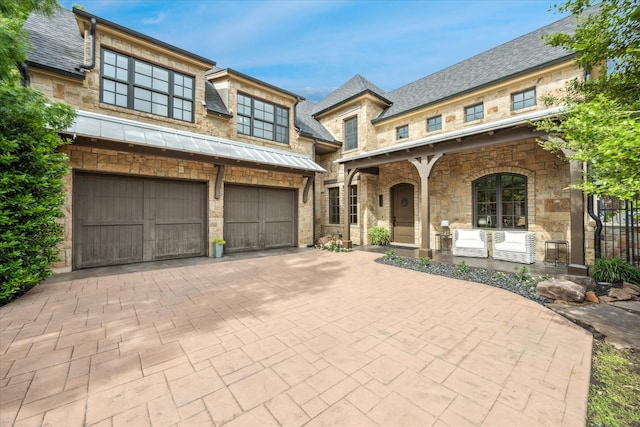 933 Glenhurst Rd, Keller, TX 76248 - view of front of house with a garage, decorative driveway, a standing seam roof, stone siding, and a porch