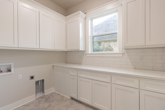 3928 Hogan Dr, Tyler, TX 75709 - washroom featuring cabinet space, hookup for an electric dryer, baseboards, and washer hookup