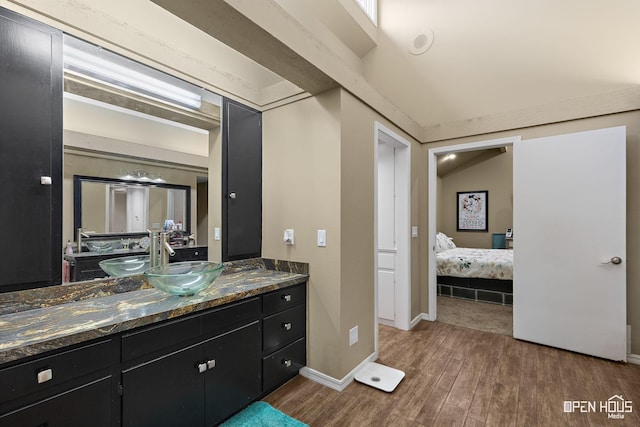 4403 Nassau Dr, Wichita Falls, TX 76308 - ensuite bathroom with wood finished floors, vanity, and baseboards