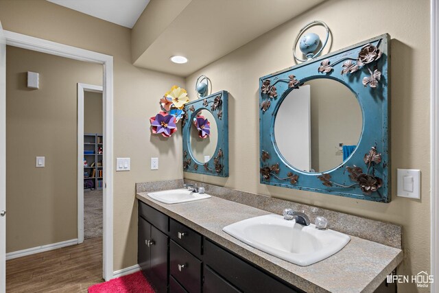 4403 Nassau Dr, Wichita Falls, TX 76308 - full bathroom with wood finished floors, double vanity, and baseboards