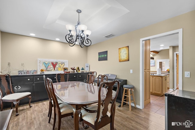 4403 Nassau Dr, Wichita Falls, TX 76308 - dining space featuring light wood-style floors, a chandelier, a tray ceiling, recessed lighting, and baseboards