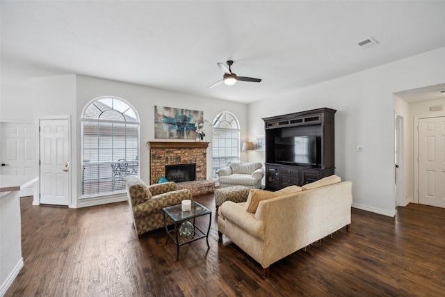 8630 Hidden Spring Dr, Frisco, TX 75034 - living area featuring a ceiling fan, dark wood-style floors, baseboards, and a brick fireplace