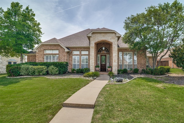 2305 Rosser Ct, Rowlett, TX 75088 - french country inspired facade with brick siding, a front yard, and a shingled roof
