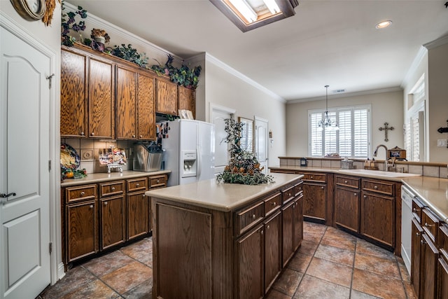 2305 Rosser Ct, Rowlett, TX 75088 - kitchen featuring a sink, white appliances, light countertops, crown molding, and a kitchen island