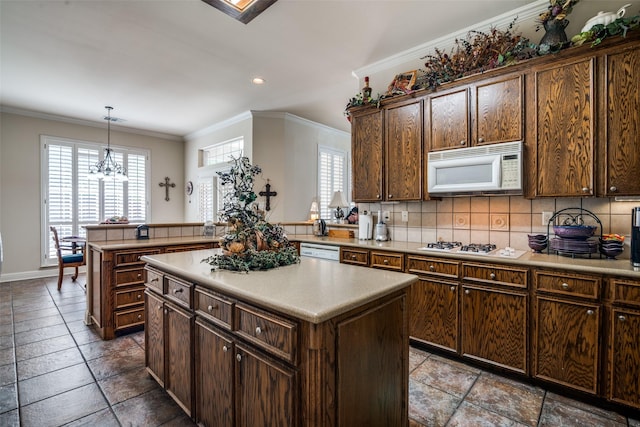 2305 Rosser Ct, Rowlett, TX 75088 - kitchen with white appliances, crown molding, decorative backsplash, a kitchen island, and light countertops