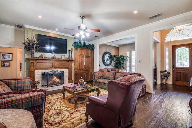 2305 Rosser Ct, Rowlett, TX 75088 - living area with healthy amount of natural light, dark wood-style floors, a lit fireplace, recessed lighting, and ceiling fan