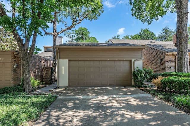 6433 Southpoint Dr, Dallas, TX 75248 - view of front of home featuring concrete driveway, a chimney, an attached garage, and stucco siding