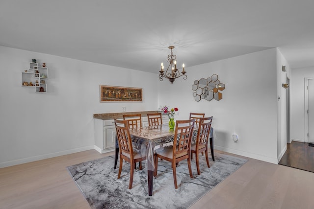 6433 Southpoint Dr, Dallas, TX 75248 - dining space featuring light wood-type flooring, a chandelier, and baseboards