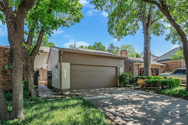6433 Southpoint Dr, Dallas, TX 75248 - mid-century modern home featuring an attached garage, driveway, stucco siding, and a chimney