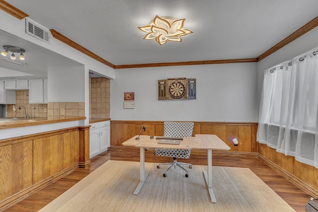 6433 Southpoint Dr, Dallas, TX 75248 - office featuring light wood finished floors, a sink, a wainscoted wall, ornamental molding, and wooden walls