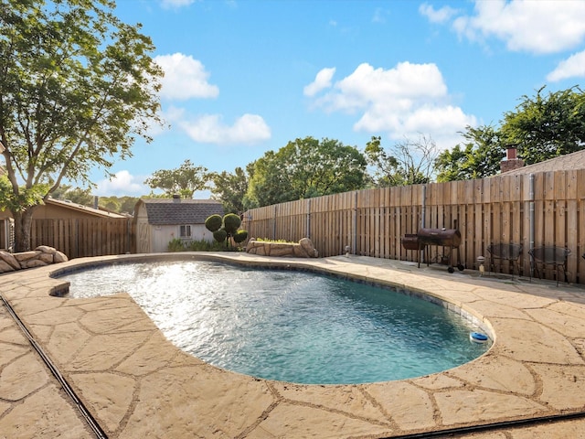 8521 Brookridge Dr, North Richland Hills, TX 76182 - view of swimming pool with a fenced backyard, a patio area, and a storage unit