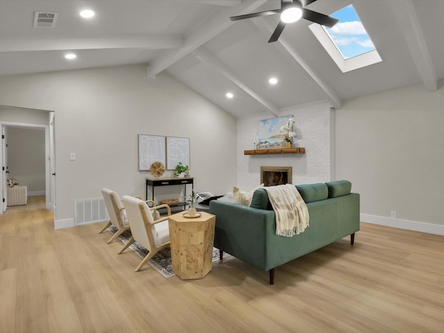 8521 Brookridge Dr, North Richland Hills, TX 76182 - living area with a skylight, light wood-style floors, a ceiling fan, a fireplace, and recessed lighting