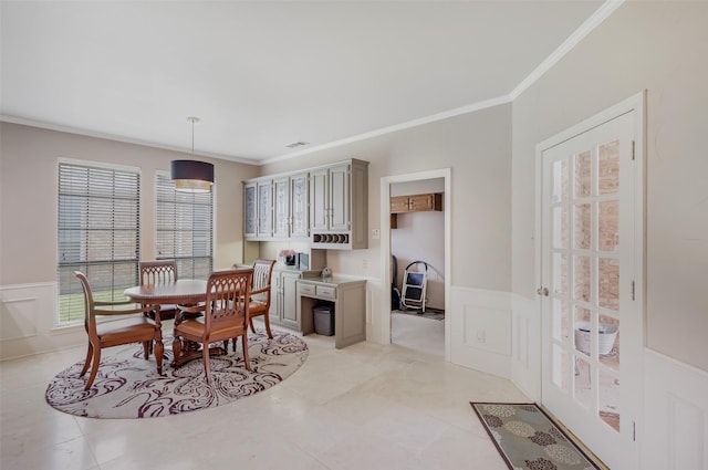 3213 Louis Dr, Plano, TX 75023 - dining area featuring ornamental molding, a wainscoted wall, a decorative wall, and light tile patterned floors