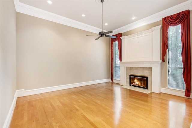 3213 Louis Dr, Plano, TX 75023 - unfurnished living room with crown molding, light wood-style floors, a fireplace, baseboards, and a ceiling fan