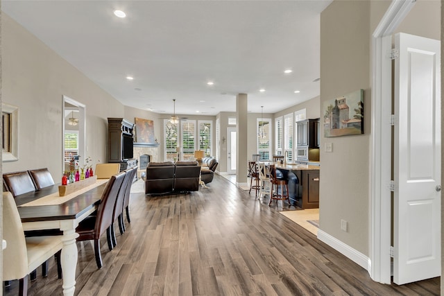 9012 Terrel St, Lantana, TX 76226 - dining area featuring wood finished floors, recessed lighting, baseboards, and a fireplace