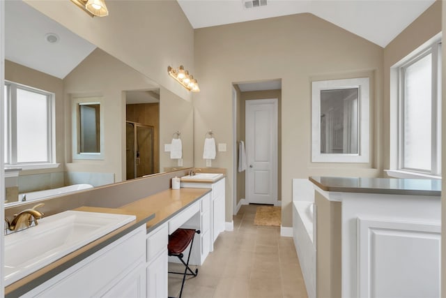 9012 Terrel St, Lantana, TX 76226 - full bathroom with lofted ceiling, double vanity, a garden tub, a stall shower, and tile patterned flooring