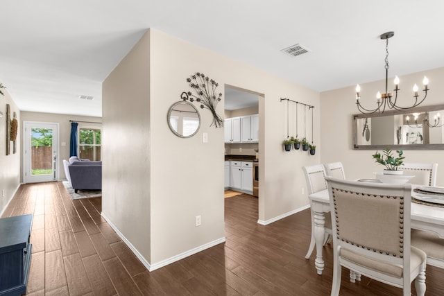 8308 Montecito Dr, Denton, TX 76210 - dining space with a chandelier, dark wood finished floors, and baseboards