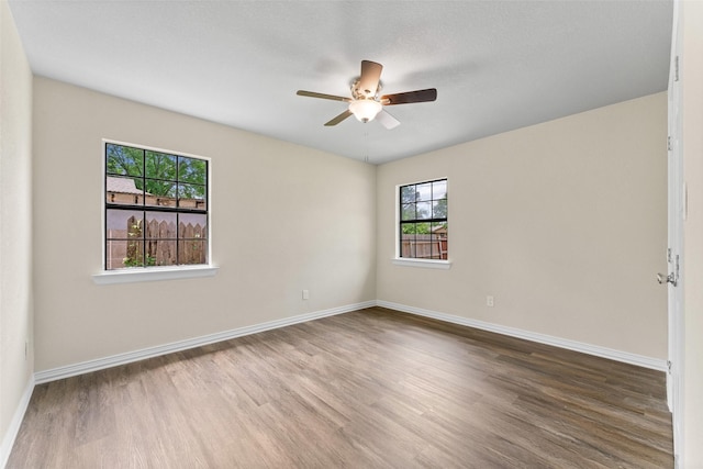 1008 Pleasant Dr, Dallas, TX 75217 - empty room with wood finished floors, baseboards, and a ceiling fan