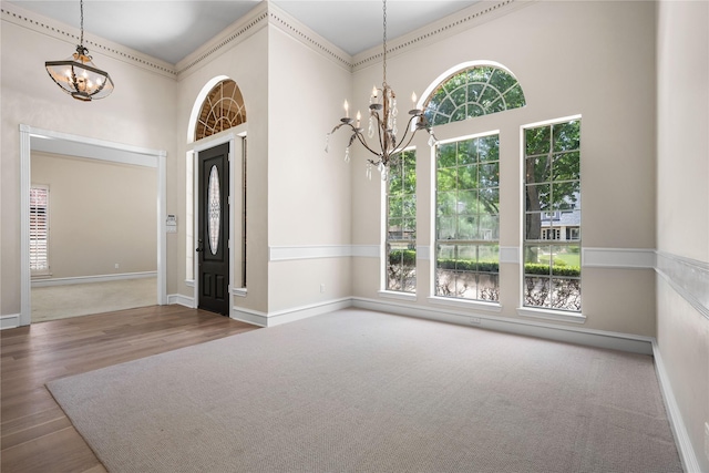934 Hills Creek Dr, Mckinney, TX 75072 - foyer featuring a chandelier, healthy amount of natural light, a high ceiling, and wood finished floors