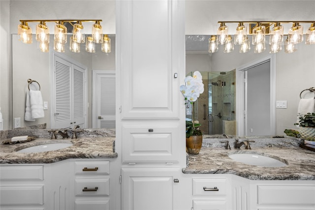 934 Hills Creek Dr, Mckinney, TX 75072 - bathroom with a shower stall, a chandelier, and two vanities