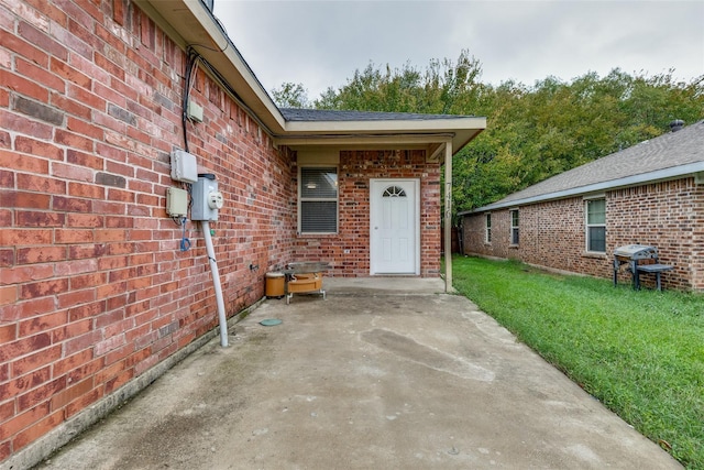 7418 Novella Dr, Fort Worth, TX 76134 - entrance to property featuring brick siding, a patio area, and a yard
