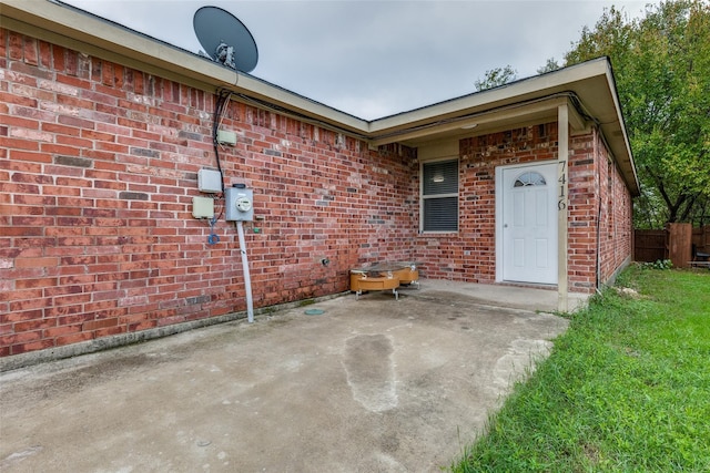 7418 Novella Dr, Fort Worth, TX 76134 - view of exterior entry with brick siding, a patio, and fence