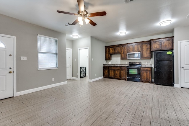 7418 Novella Dr, Fort Worth, TX 76134 - kitchen featuring black appliances, a ceiling fan, light wood finished floors, and dark brown cabinets
