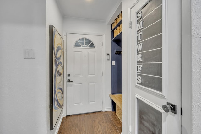 mudroom featuring ornamental molding and wood finished floors