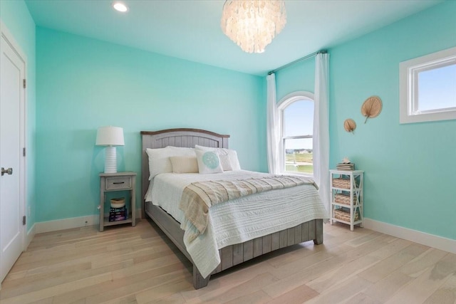 477 Willow Moon Ranch Rd, Crawford, TX 76638 - bedroom featuring multiple windows, wood finished floors, a chandelier, baseboards, and recessed lighting