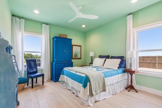 477 Willow Moon Ranch Rd, Crawford, TX 76638 - bedroom with multiple windows, light wood-style flooring, recessed lighting, and baseboards