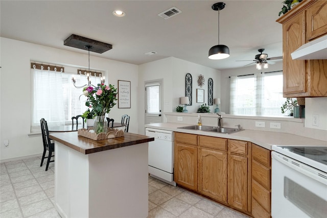 10617 Big Oak Dr, Fort Worth, TX 76131 - kitchen featuring white appliances, a sink, a peninsula, ceiling fan, and decorative light fixtures
