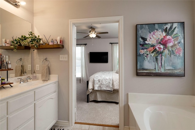10617 Big Oak Dr, Fort Worth, TX 76131 - full bath with ensuite bathroom, a ceiling fan, vanity, a bath, and baseboards