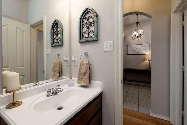 10617 Big Oak Dr, Fort Worth, TX 76131 - bathroom with vanity, wood finished floors, and a chandelier