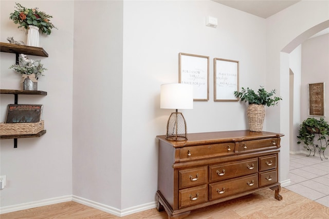 10617 Big Oak Dr, Fort Worth, TX 76131 - hallway featuring arched walkways, baseboards, and light tile patterned flooring