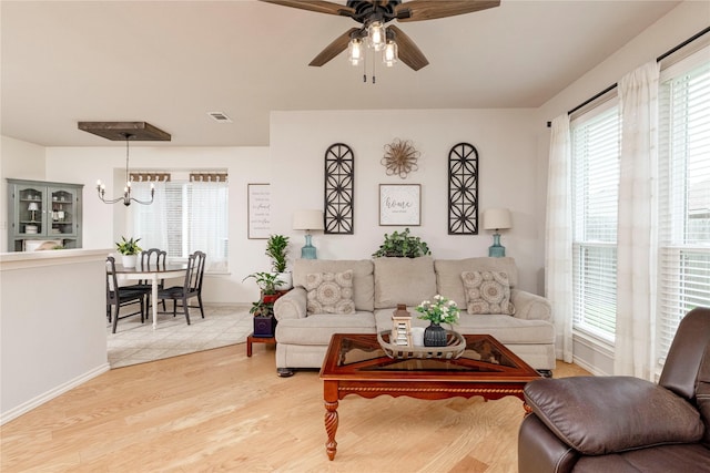 10617 Big Oak Dr, Fort Worth, TX 76131 - living area featuring healthy amount of natural light, a ceiling fan, a chandelier, and baseboards
