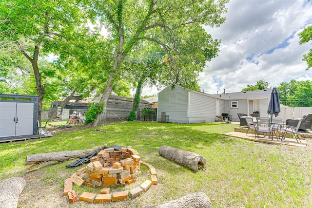 3444 Kellogg Ave, Dallas, TX 75216 - view of yard featuring a fire pit, a shed, a patio area, and an outbuilding