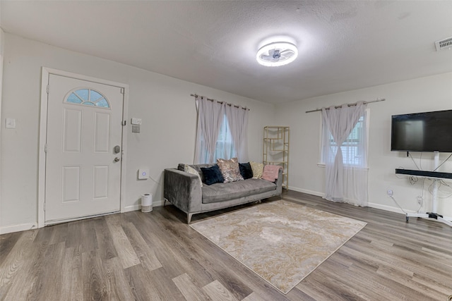3444 Kellogg Ave, Dallas, TX 75216 - living area with wood finished floors, baseboards, and healthy amount of natural light
