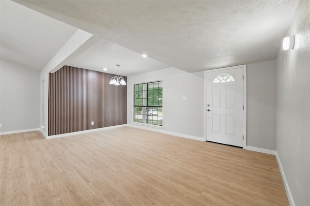 2833 Miller Pl, Mesquite, TX 75150 - unfurnished living room with light wood-style floors, a chandelier, baseboards, a textured ceiling, and recessed lighting