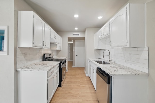 2833 Miller Pl, Mesquite, TX 75150 - kitchen with stainless steel appliances, a sink, light wood-style flooring, white cabinetry, and recessed lighting