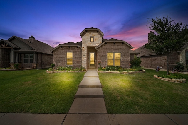 481 Washington Ave, Waxahachie, TX 75165 - view of front facade featuring a front lawn, brick siding, and stone siding