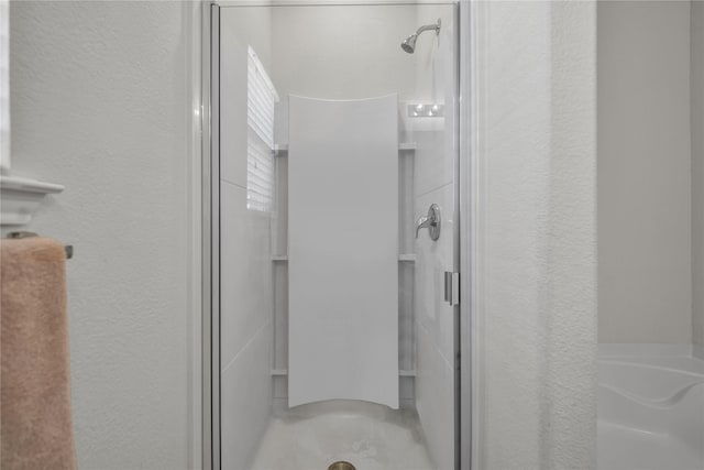 2336 Bermont Red Ln, Fort Worth, TX 76131 - bathroom featuring a stall shower, a textured wall, and a tub