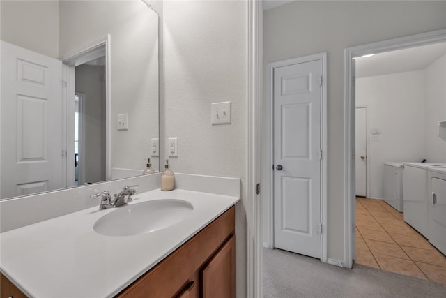 2336 Bermont Red Ln, Fort Worth, TX 76131 - bathroom with washer and clothes dryer, tile patterned flooring, and vanity