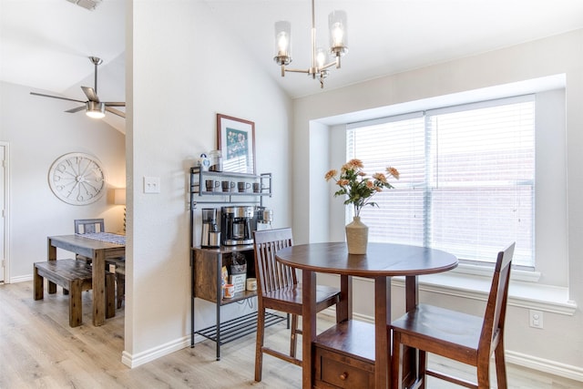 2836 Dawn Spring Dr, Little Elm, TX 75068 - dining space with vaulted ceiling, light wood finished floors, a chandelier, baseboards, and a ceiling fan