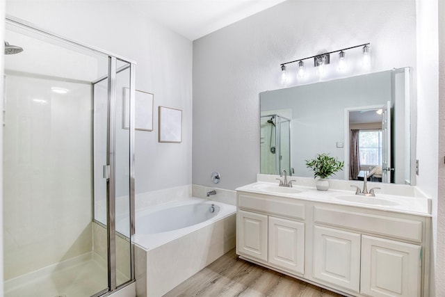 2836 Dawn Spring Dr, Little Elm, TX 75068 - ensuite bathroom featuring a shower stall, double vanity, a garden tub, and wood finished floors