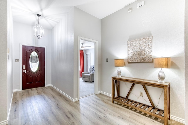 2836 Dawn Spring Dr, Little Elm, TX 75068 - entryway with wood finished floors, a chandelier, and baseboards