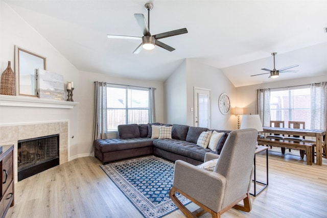 2836 Dawn Spring Dr, Little Elm, TX 75068 - living area with ceiling fan, lofted ceiling, light wood-style floors, and a tile fireplace