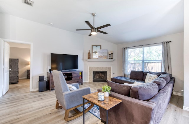 2836 Dawn Spring Dr, Little Elm, TX 75068 - living area featuring ceiling fan, lofted ceiling, light wood-type flooring, a tiled fireplace, and baseboards